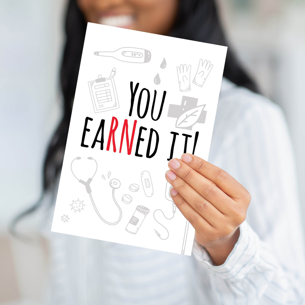 Close-up of a person holding the You EaRNEed It card, showing the thick 320 GSM professional paper.