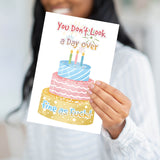 A person holding the "Fine as F*ck" card to demonstrate the professional weight and large scale of the product.