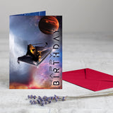 The "Out of This World" birthday card shown next to its premium red self-adhesive envelope.